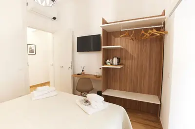 a small bedroom with a bed and a desk at Napodano Apartments - Roma in Rome