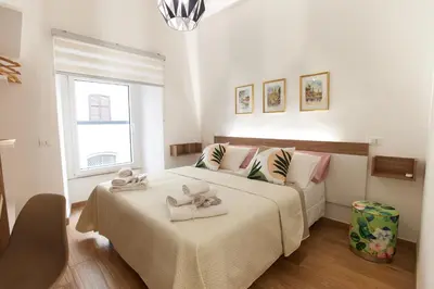 a bedroom with a bed with towels on it at Napodano Apartments - Roma in Rome