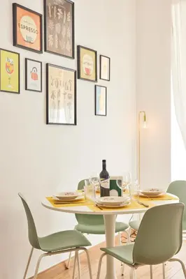 a dining room with a table and chairs at Napodano Apartments - Roma in Rome