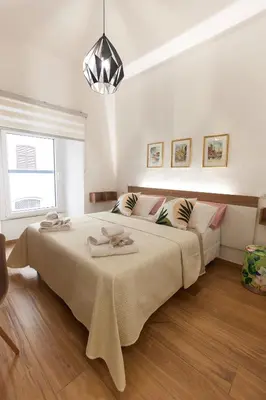 a bedroom with a large bed with two towels on it at Napodano Apartments - Roma in Rome