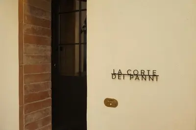 a door with the words la crate dept paint on it at La Corte Dei Panni in Rome