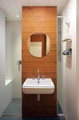 a bathroom with a sink and a wooden wall at La Corte Dei Panni in Rome