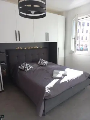 a bedroom with a large bed with two pillows on it at Andrew's Suite Rome center in Rome