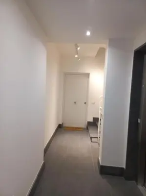 an empty hallway with a white wall and a door at Andrew's Suite Rome center in Rome