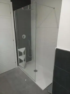 a bathroom with a shower with a glass door at Andrew's Suite Rome center in Rome