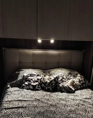 an unmade bed with two lights on top of it at Andrew's Suite Rome center in Rome