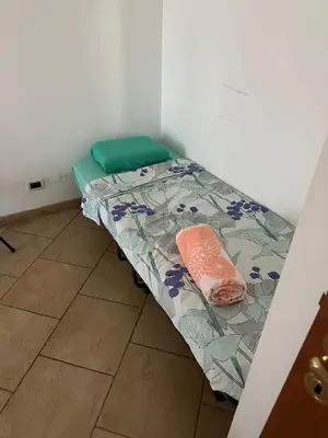 a small bed in a corner of a room at Nathan House, Malatesta in Rome