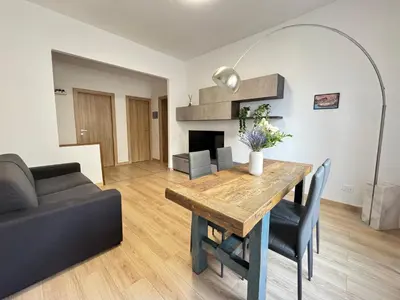 a living room with a table and a couch at House Garden 44 - 15 minutes from Vatican Museums in Rome