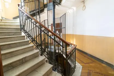 a staircase in a building with a person walking down it at Apartment Next to St Peter in Rome