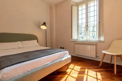 a bedroom with a bed and a table and a window at Apartment Next to St Peter in Rome