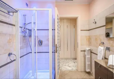 a bathroom with a shower with a glass door at La Dolce Vita Of Via Veneto - Prestigious Apartment With Wonderful Terrace In the Historic Center in Rome