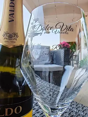 a bottle of wine and a glass on a table at La Dolce Vita Of Via Veneto - Prestigious Apartment With Wonderful Terrace In the Historic Center in Rome