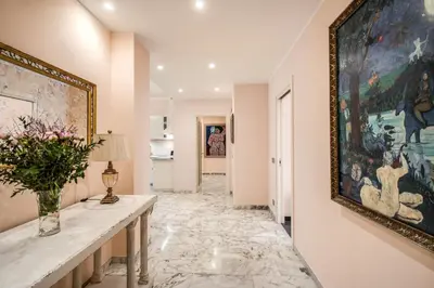 a hallway with a large painting on the wall at La Dolce Vita Of Via Veneto - Prestigious Apartment With Wonderful Terrace In the Historic Center in Rome