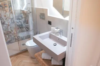 a white bathroom with a sink and a toilet at Maison Vaticano - A few steps from Vatican and San Peter in Rome