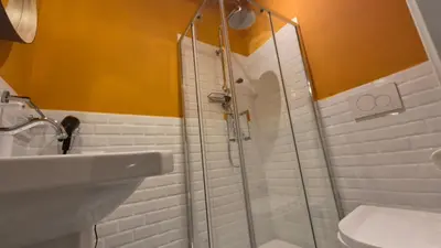 a bathroom with a shower and a sink and a toilet at IAIO Testaccio Retrò in Rome