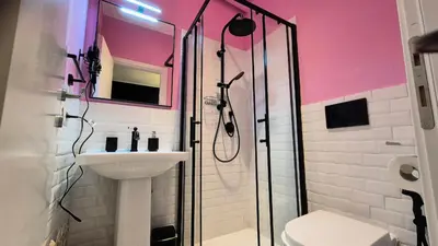 a bathroom with a shower and a sink and a toilet at IAIO Testaccio Retrò in Rome