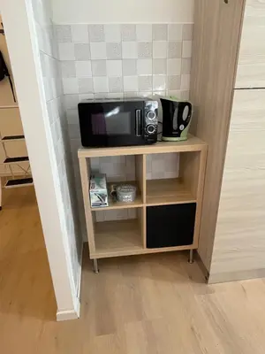 a microwave on a small shelf in a room at Enjoy Rhome in Rome
