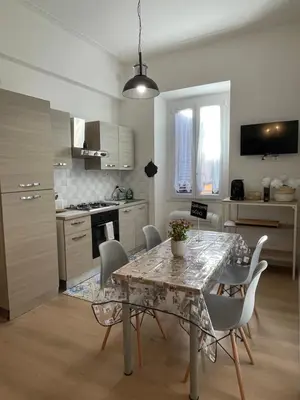 a kitchen with a table and chairs in a kitchen at Enjoy Rhome in Rome