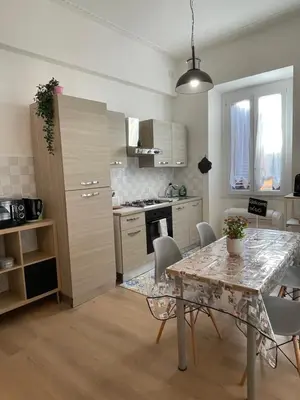 a kitchen and dining room with a table and chairs at Enjoy Rhome in Rome