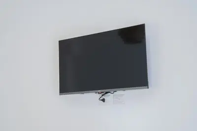 a flat screen tv hanging on a white wall at VaticaNella 10 min walk from Vatican Museums in Rome