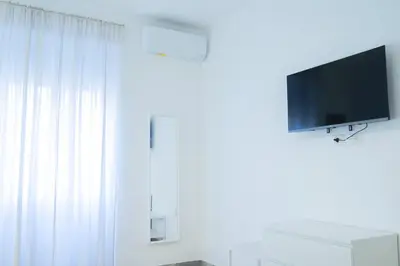 a white room with a tv and a window at VaticaNella 10 min walk from Vatican Museums in Rome