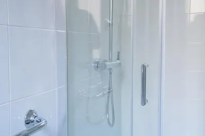 a shower with a glass door in a bathroom at VaticaNella 10 min walk from Vatican Museums in Rome