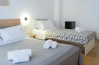 a bedroom with two beds with white towels on them at VaticaNella 10 min walk from Vatican Museums in Rome