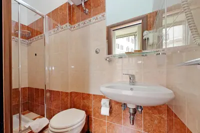 a bathroom with a sink and a toilet and a mirror at Domus Maggiore in Rome