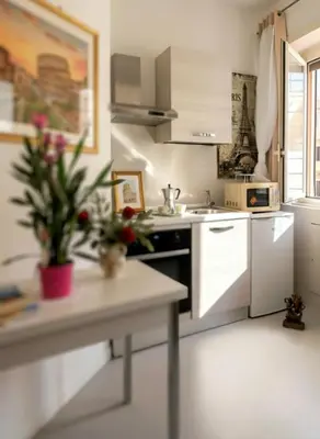 a kitchen with white appliances and a table at Rome Castle&Dome in Rome