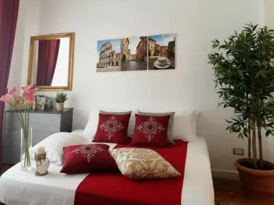 a bedroom with a red and white bed with red pillows at Rome Castle&Dome in Rome