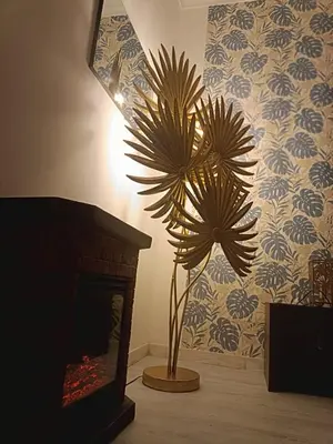 a living room with a plant in front of a fireplace at Rome Castle&Dome in Rome