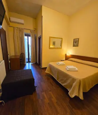 a bedroom with a bed with two towels on it at Hotel Azzurra in Rome