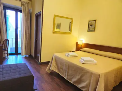 a bedroom with a bed with two towels on it at Hotel Azzurra in Rome