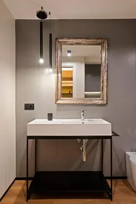 a bathroom with a sink and a mirror at Casa Scipioni by Hili in Rome