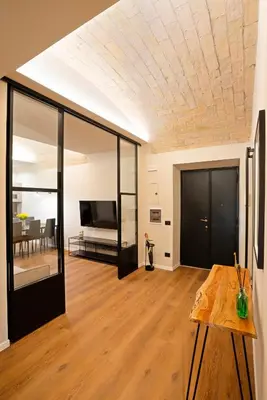 a living room with a coffered ceiling and a table at Casa Scipioni by Hili in Rome