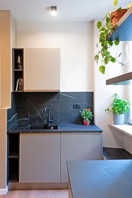 a kitchen with white cabinets and a sink at Casa Scipioni by Hili in Rome