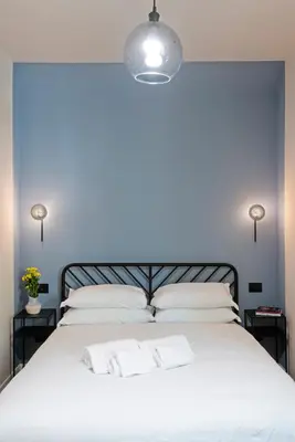 a bedroom with a large white bed with two pillows at Casa Scipioni by Hili in Rome
