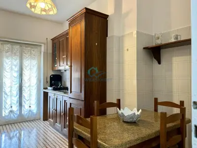 a kitchen with a table and a dining room at Typical Grandma's Roman Apartment in Rome