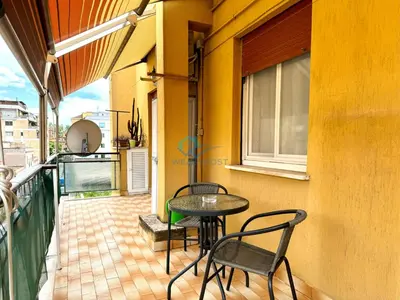 a patio with a table and chairs on a balcony at Typical Grandma's Roman Apartment in Rome