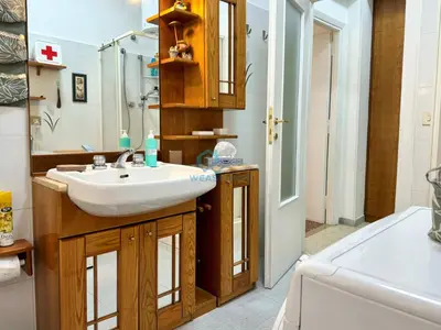 a bathroom with a white sink and a shower at Typical Grandma's Roman Apartment in Rome