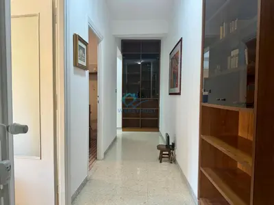 a hallway with a door and a chair in a room at Typical Grandma's Roman Apartment in Rome