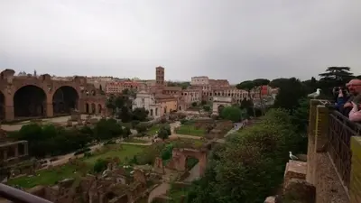 a group of people standing on a balcony looking at a city at Charming Apartment Near Roman Forum - 60 m² in Rome
