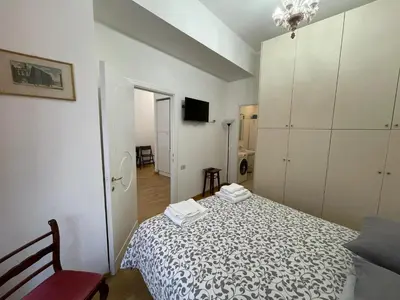 a small bedroom with a bed and a tv at Charming Apartment Near Roman Forum - 60 m² in Rome