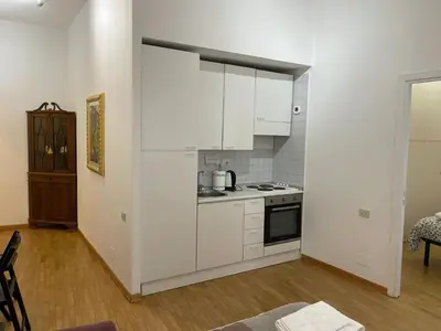a kitchen with white cabinets and a stove at Charming Apartment Near Roman Forum - 60 m² in Rome
