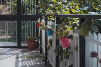 a fence with potted plants hanging on it at Vatican 4 BedRoom Apartment with Private Parking in Rome