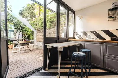 a kitchen with a table and a patio at Unique Garden Apartment near Caracalla Baths in Rome