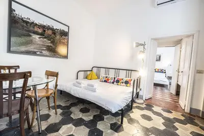 a bedroom with a bed and a table and a dining room at Unique Garden Apartment near Caracalla Baths in Rome