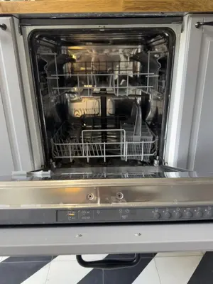 an open dishwasher with dishes inside of it at Unique Garden Apartment near Caracalla Baths in Rome
