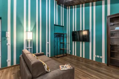a living room with a couch and a television at Luciana Vatican Apartment in Rome