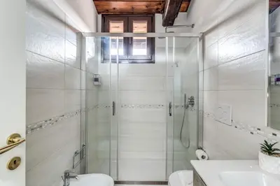 a bathroom with a shower and a toilet and a sink at Luciana Vatican Apartment in Rome
